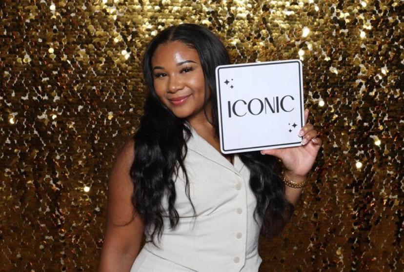 Guest with a gold sequin backdrop at a Philadelphia event photo booth