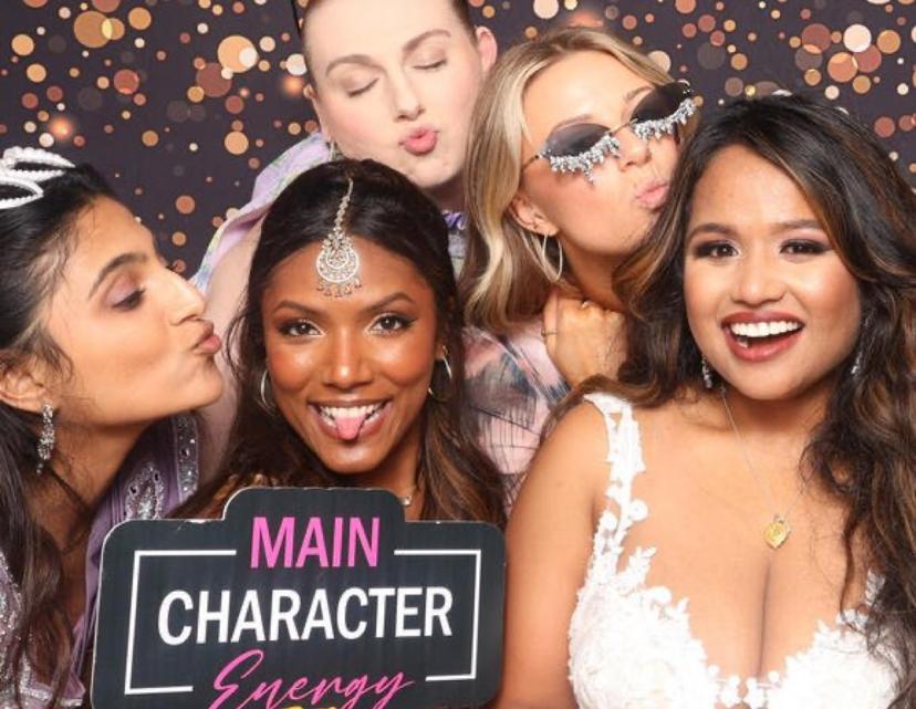 Friends posing with props in a Philadelphia photo booth rental