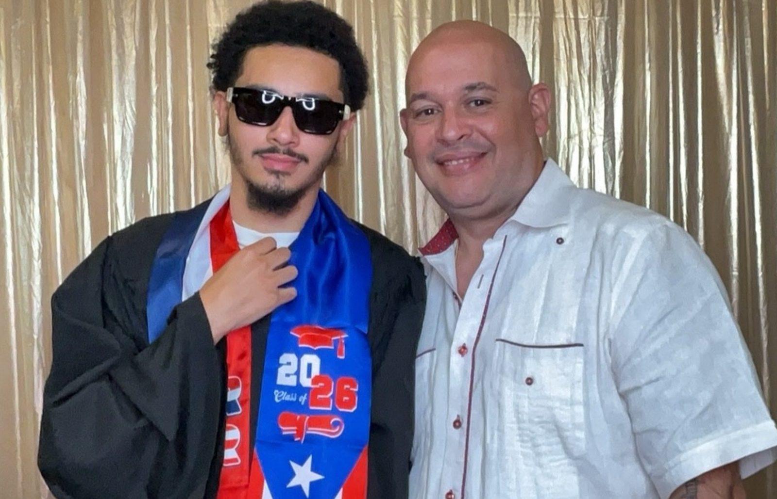 Graduate wearing a Puerto Rico Class of 2026 stole posing with his father in a photo booth
