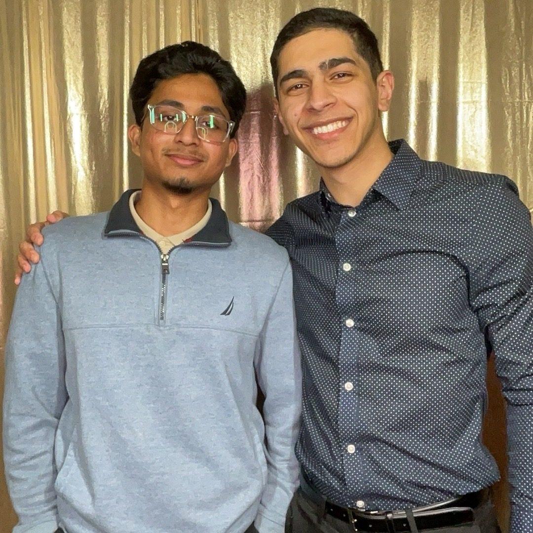 Two guests in formal attire posing in a Philadelphia event photo booth